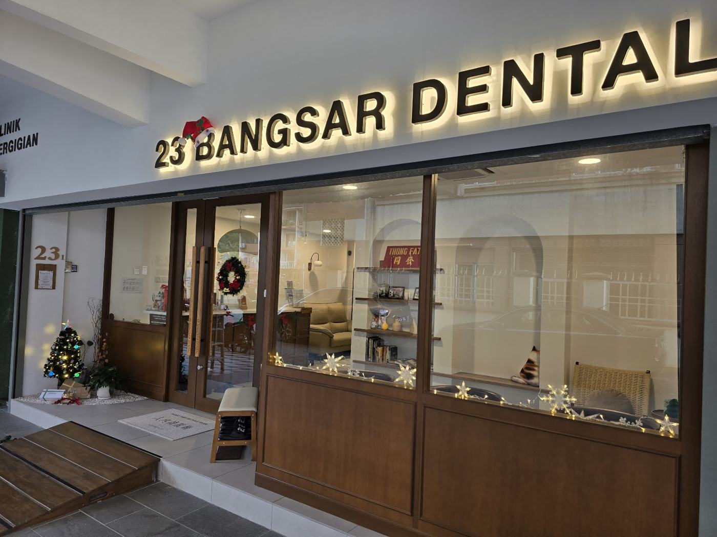 The clinic storefront with its lit signboard